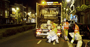 Photo of workers loading the bin lorry for collection